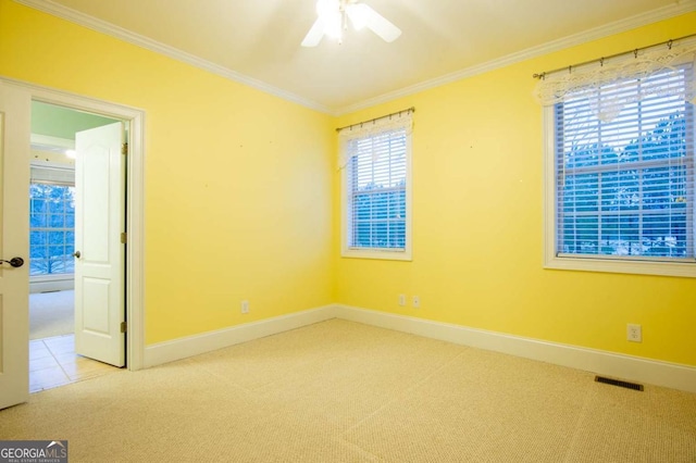 carpeted empty room featuring ceiling fan and crown molding