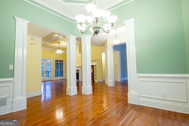 spare room with crown molding, french doors, hardwood / wood-style flooring, and an inviting chandelier