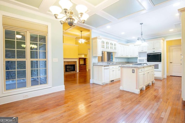 1010 Lane Creek Ct, Bishop, GA 30621 - kitchen with a chandelier, light wood finished floors, white appliances, white cabinetry, and a kitchen island