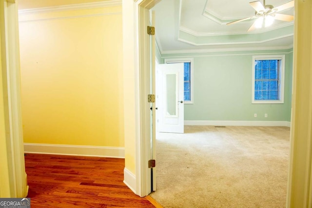 hallway featuring hardwood / wood-style floors and crown molding