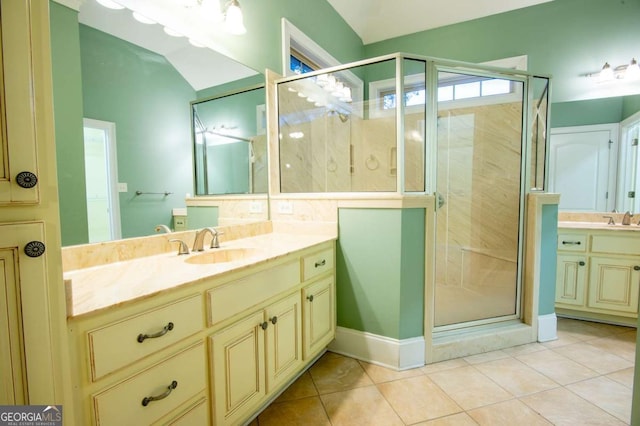 bathroom with tile patterned floors, vanity, and an enclosed shower