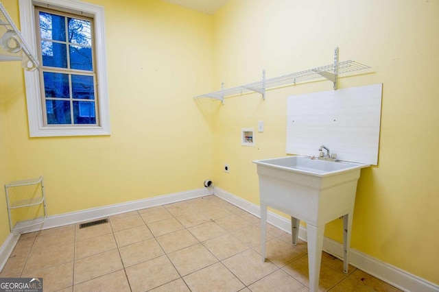 laundry area with electric dryer hookup, light tile patterned floors, and hookup for a washing machine