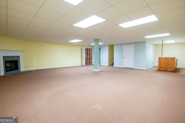 basement with light carpet and a drop ceiling