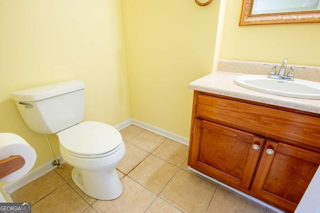 bathroom featuring tile patterned floors, vanity, and toilet