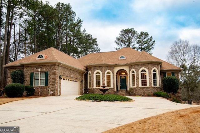 1010 Lane Creek Ct, Bishop, GA 30621 - view of front facade featuring a garage, concrete driveway, and brick siding