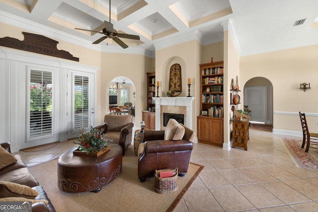 tiled living room featuring ceiling fan, coffered ceiling, beamed ceiling, a towering ceiling, and ornamental molding