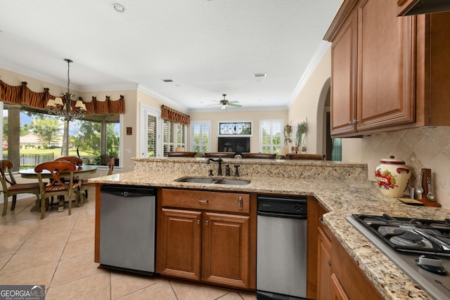 kitchen with ceiling fan with notable chandelier, sink, decorative backsplash, light tile patterned floors, and appliances with stainless steel finishes