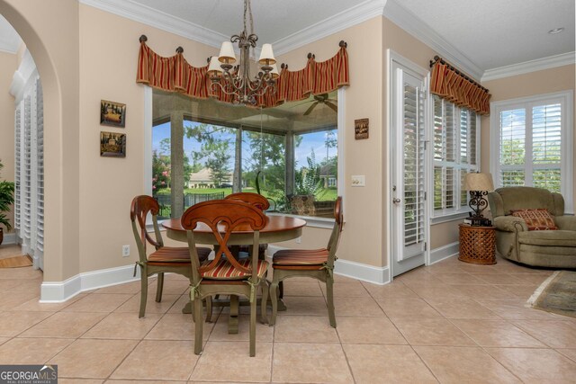 dining room featuring crown molding, light tile patterned floors, and a chandelier