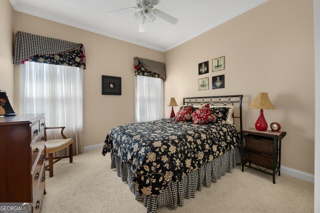 carpeted bedroom featuring ceiling fan and ornamental molding