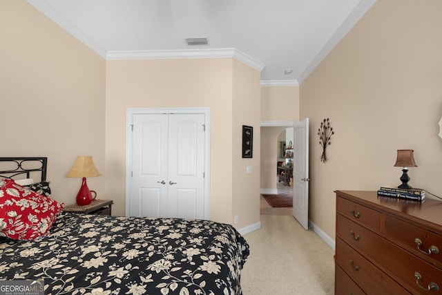 bedroom featuring a closet and crown molding