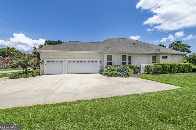 single story home featuring a front lawn and a garage