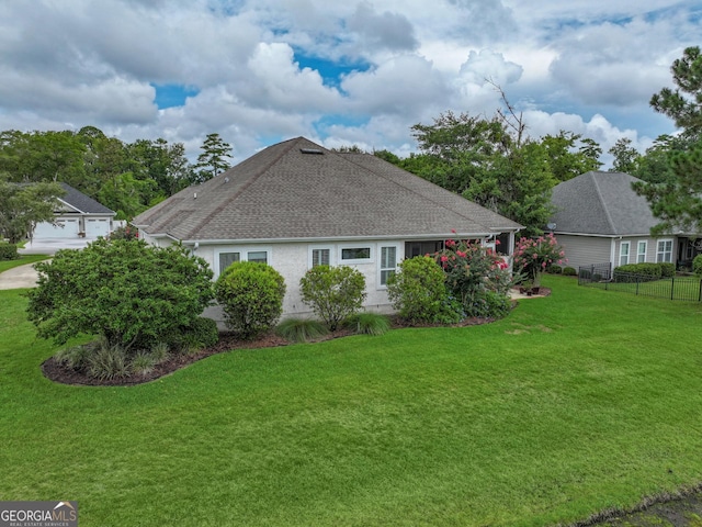 view of side of home with a lawn