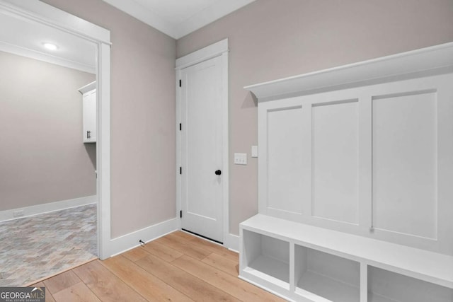 mudroom featuring ornamental molding and light wood-type flooring