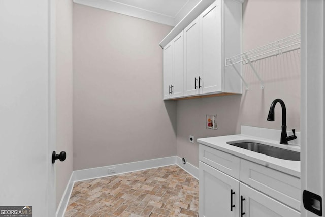 washroom with sink, cabinets, washer hookup, hookup for an electric dryer, and ornamental molding