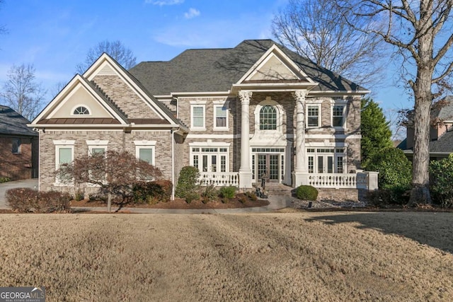 view of front of home featuring french doors and a front lawn