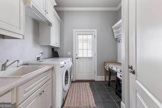 laundry room with ornamental molding, washer and clothes dryer, cabinets, and sink