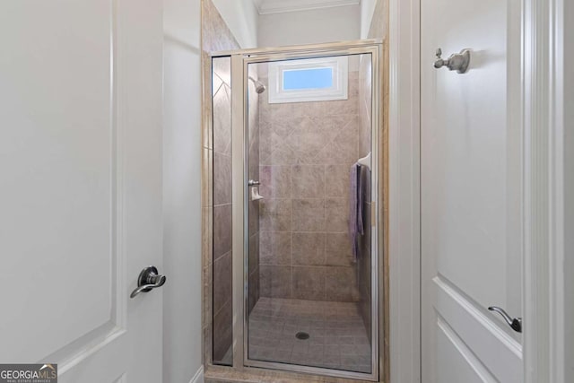 bathroom featuring crown molding and an enclosed shower