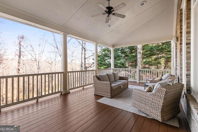 wooden terrace featuring an outdoor living space and ceiling fan