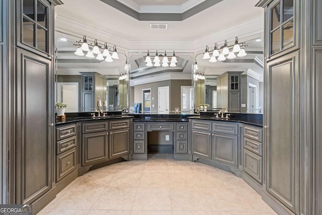 bathroom featuring a raised ceiling, tile patterned flooring, vanity, and ornamental molding