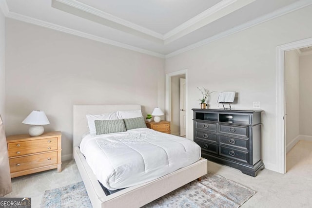 carpeted bedroom with a tray ceiling and crown molding