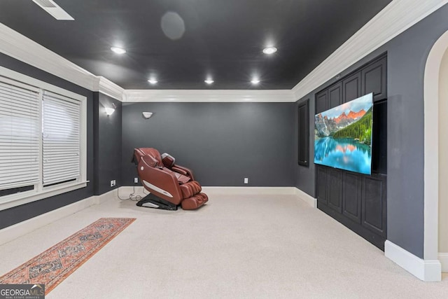 carpeted cinema room featuring crown molding