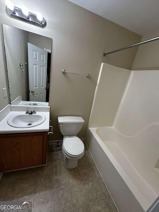 full bathroom with shower / washtub combination, vanity, a textured ceiling, and toilet