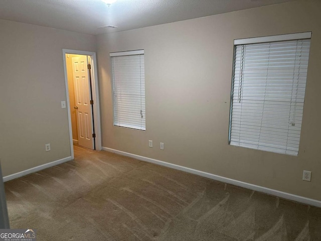 empty room with carpet flooring