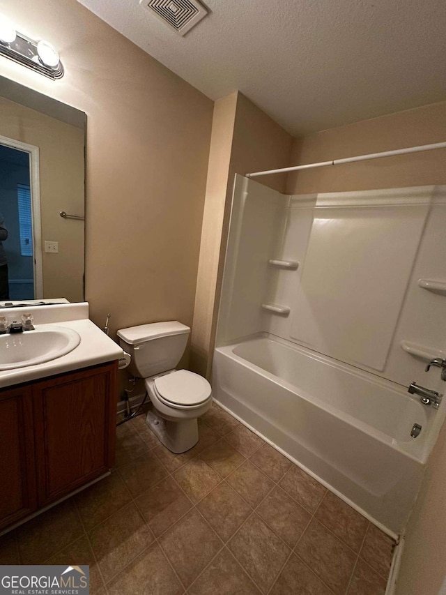 full bathroom with a textured ceiling, vanity, shower / bathtub combination, and toilet