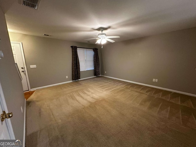 carpeted spare room with ceiling fan