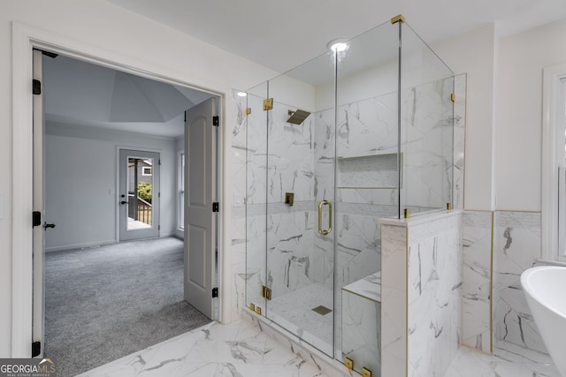 bathroom featuring shower with separate bathtub and tile walls