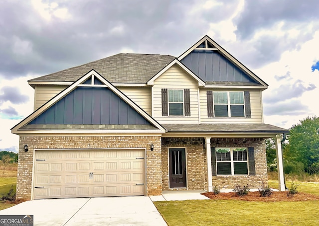 craftsman-style home featuring covered porch and a front yard