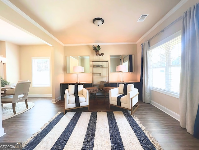 sitting room featuring dark hardwood / wood-style flooring, a wealth of natural light, and crown molding