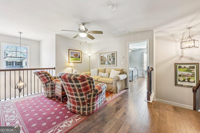 living room with ceiling fan and dark hardwood / wood-style floors