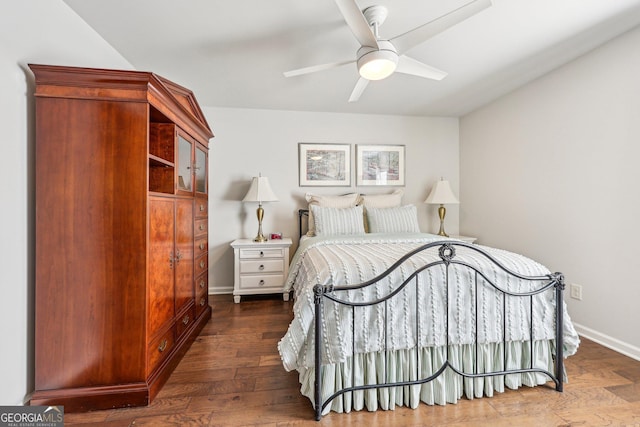 bedroom with dark hardwood / wood-style flooring and ceiling fan