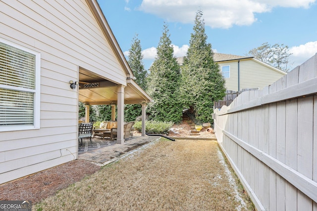 view of yard featuring an outdoor living space and a patio