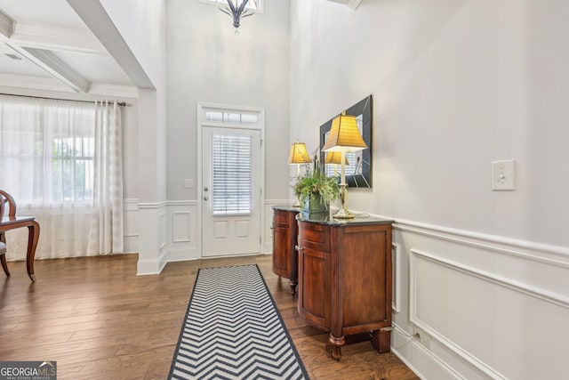 entrance foyer featuring crown molding, beamed ceiling, dark hardwood / wood-style floors, and coffered ceiling