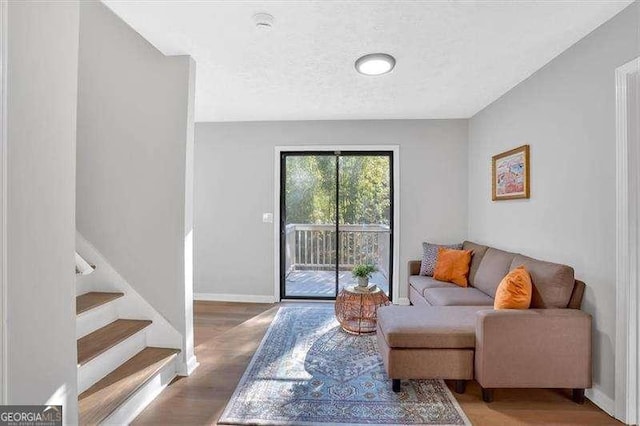 living room with a textured ceiling and hardwood / wood-style flooring