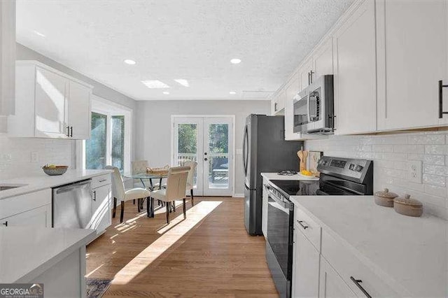 kitchen featuring white cabinetry, appliances with stainless steel finishes, and french doors