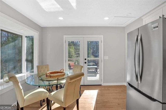 dining area featuring light hardwood / wood-style flooring and french doors