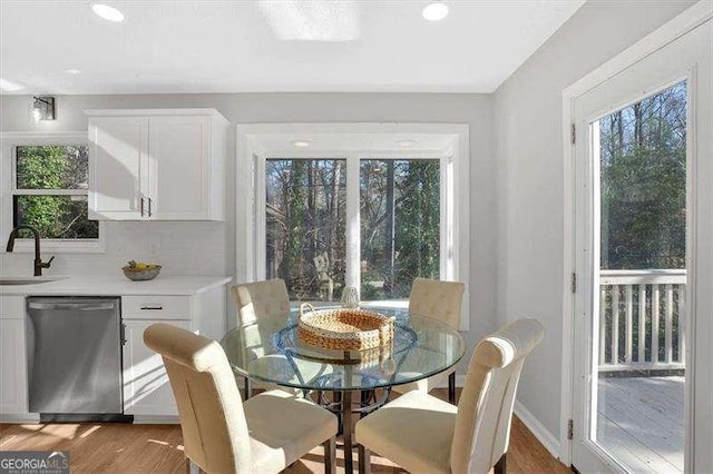 dining area with light wood-type flooring and sink