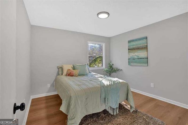 bedroom with wood-type flooring