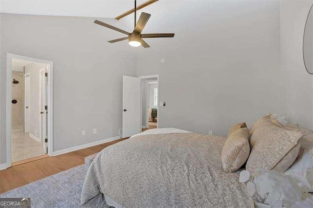 bedroom with ceiling fan, vaulted ceiling, and light wood-type flooring