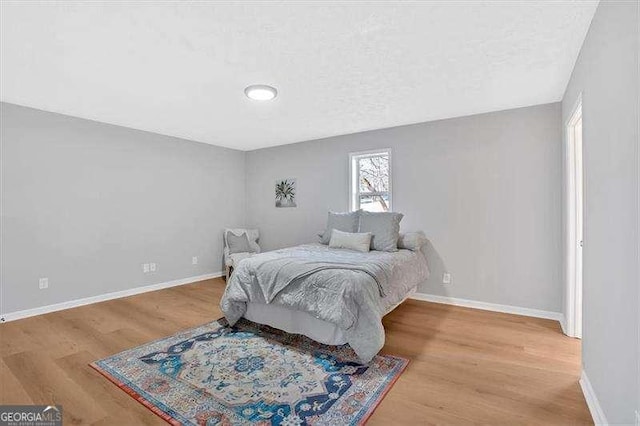 bedroom with hardwood / wood-style flooring