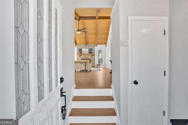 entrance foyer featuring vaulted ceiling with beams, ceiling fan, and wood ceiling