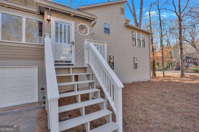 doorway to property with a garage