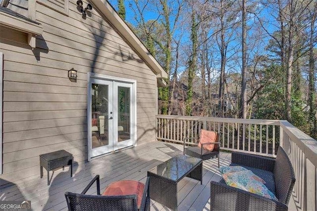 wooden terrace with french doors and an outdoor hangout area