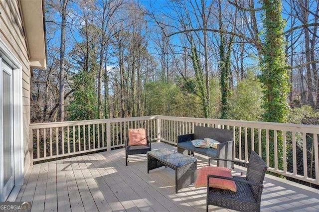 wooden terrace featuring an outdoor living space