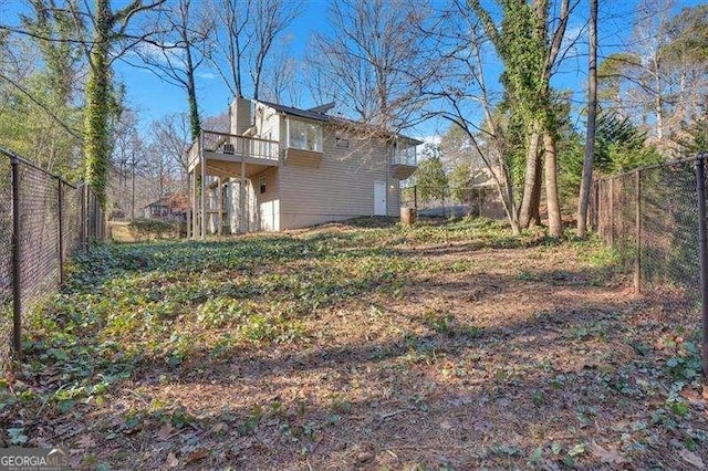 view of yard featuring a balcony