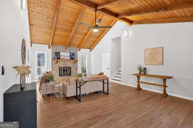 living room featuring ceiling fan, beam ceiling, wooden ceiling, and dark wood-type flooring