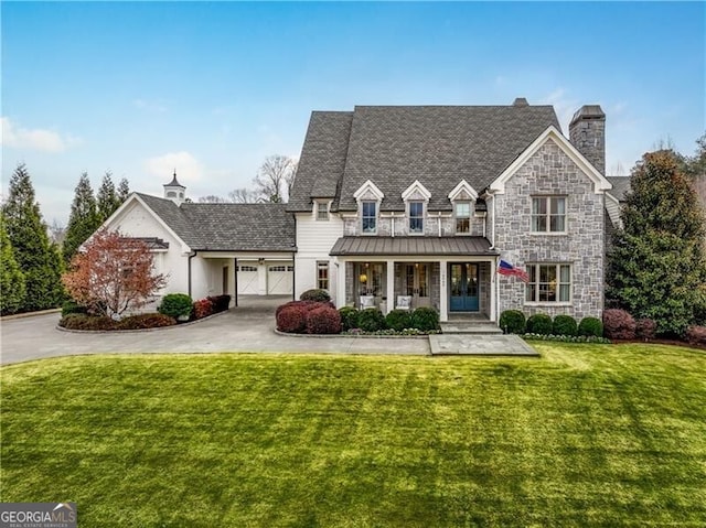 view of front of home with a front yard and covered porch